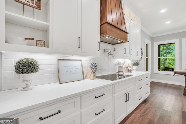 123 River Point Rd, Jackson, GA 30233 - kitchen featuring premium range hood, black electric cooktop, ornamental molding, decorative backsplash, and glass insert cabinets
