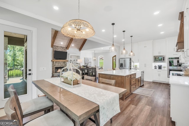 123 River Point Rd, Jackson, GA 30233 - dining area featuring a chandelier, a fireplace, wood finished floors, recessed lighting, and vaulted ceiling