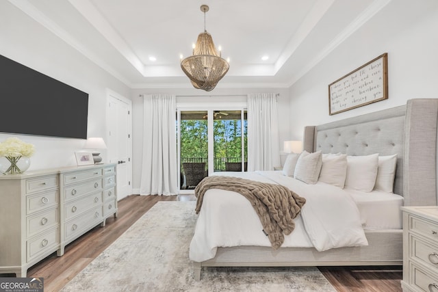 123 River Point Rd, Jackson, GA 30233 - bedroom with access to exterior, a tray ceiling, a chandelier, wood finished floors, and recessed lighting
