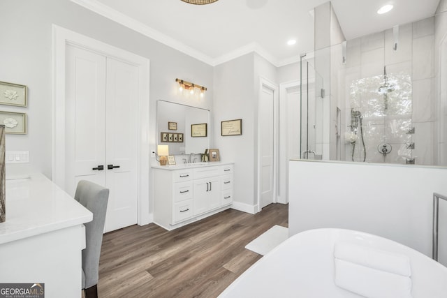 123 River Point Rd, Jackson, GA 30233 - bathroom featuring ornamental molding, a stall shower, a freestanding bath, vanity, and wood finished floors