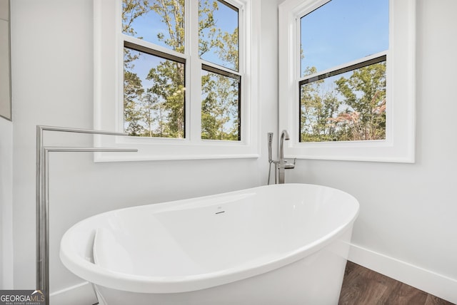 123 River Point Rd, Jackson, GA 30233 - full bath featuring a freestanding bath and wood finished floors