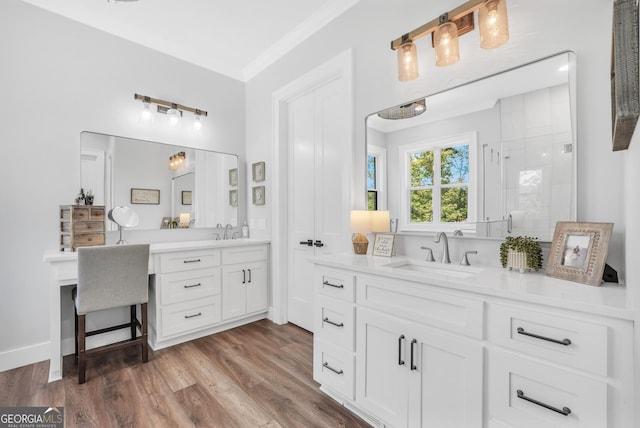 123 River Point Rd, Jackson, GA 30233 - bathroom with two vanities, a stall shower, wood finished floors, and ornamental molding