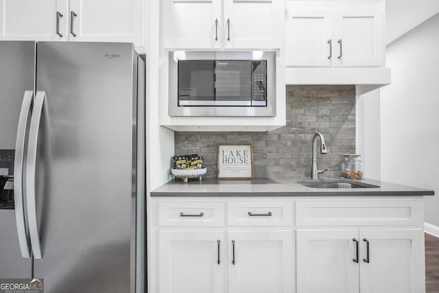 123 River Point Rd, Jackson, GA 30233 - kitchen featuring appliances with stainless steel finishes, decorative backsplash, white cabinets, and dark countertops