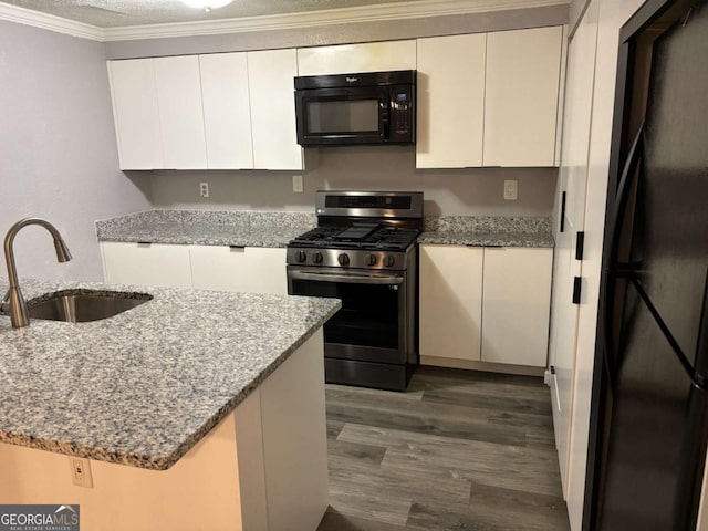 6353 Wedgeview Ct, Tucker, GA 30084 - kitchen featuring black appliances, dark wood finished floors, white cabinets, light stone countertops, and crown molding