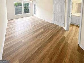 6353 Wedgeview Ct, Tucker, GA 30084 - unfurnished bedroom with wood finished floors and ensuite bath