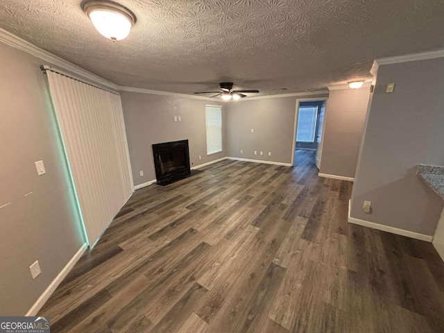 6353 Wedgeview Ct, Tucker, GA 30084 - unfurnished living room with a ceiling fan, ornamental molding, a textured ceiling, a fireplace, and dark wood-type flooring