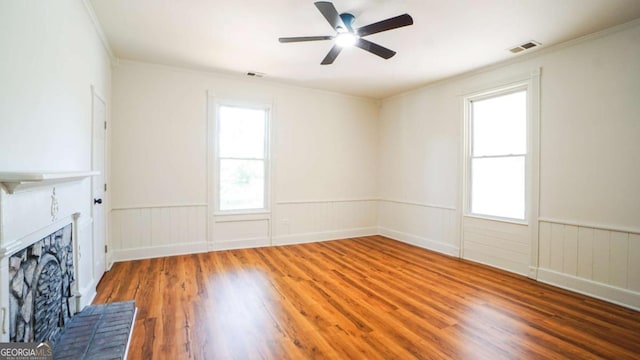 220 Confederate Ave, Dallas, GA 30132 - unfurnished living room with wood finished floors, a fireplace, a wainscoted wall, ceiling fan, and healthy amount of natural light