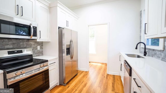 220 Confederate Ave, Dallas, GA 30132 - kitchen featuring stainless steel appliances, backsplash, light countertops, white cabinetry, and light wood-style flooring