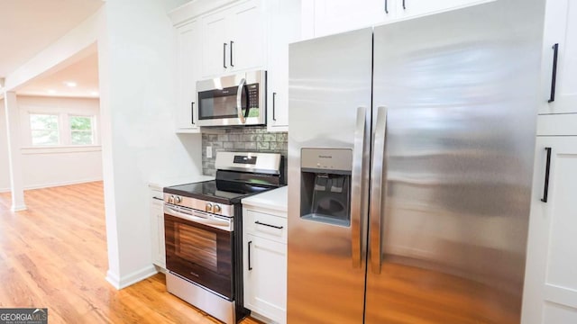 220 Confederate Ave, Dallas, GA 30132 - kitchen with stainless steel appliances, light wood-style floors, light countertops, white cabinets, and tasteful backsplash
