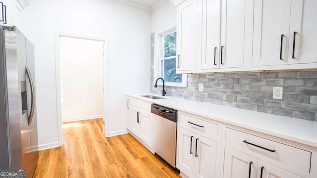 220 Confederate Ave, Dallas, GA 30132 - kitchen with appliances with stainless steel finishes, light wood-type flooring, backsplash, light countertops, and crown molding