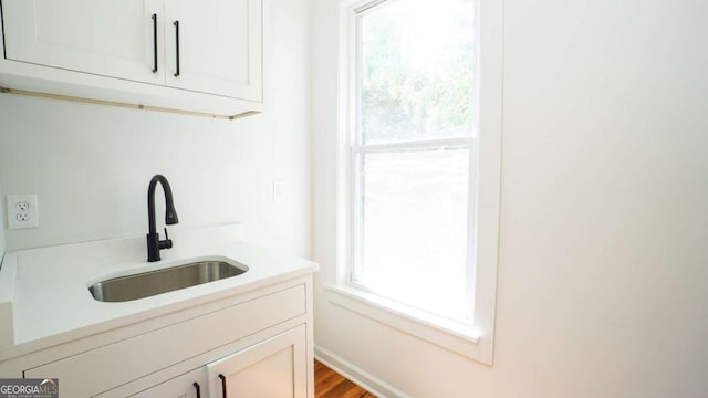 220 Confederate Ave, Dallas, GA 30132 - kitchen featuring white cabinets, light countertops, and wood finished floors