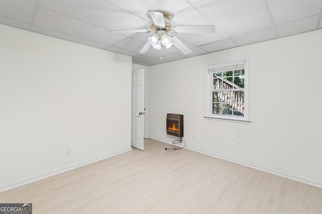 130 Sable Pointe Dr, Milton, GA 30004 - empty room featuring light wood-type flooring, heating unit, a lit fireplace, ceiling fan, and a paneled ceiling