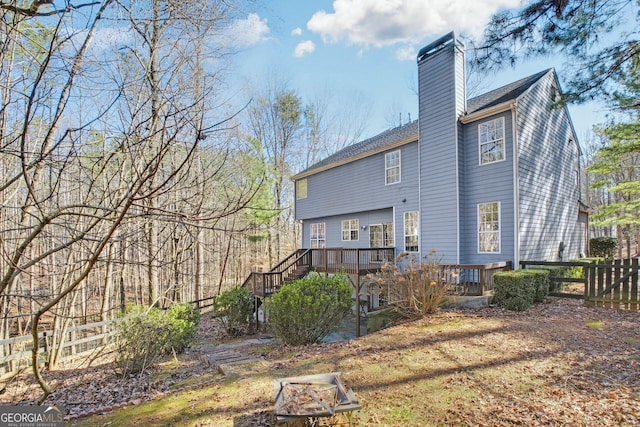 130 Sable Pointe Dr, Milton, GA 30004 - rear view of house featuring a deck, a chimney, an outdoor fire pit, stairs, and a shingled roof