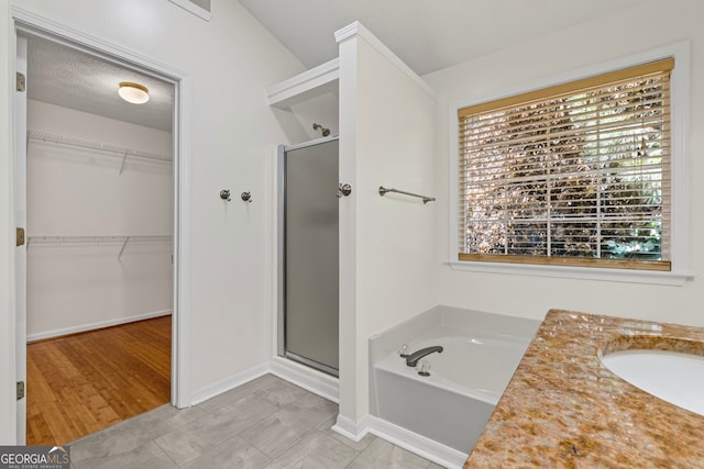 130 Sable Pointe Dr, Milton, GA 30004 - full bath with a stall shower, healthy amount of natural light, a walk in closet, and a bath