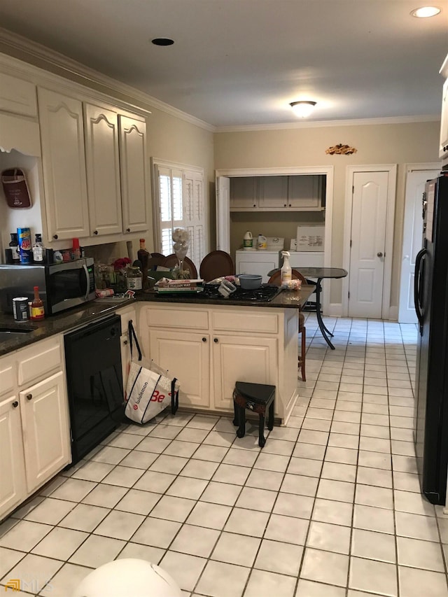 kitchen featuring crown molding, black appliances, washing machine and clothes dryer, and light tile flooring