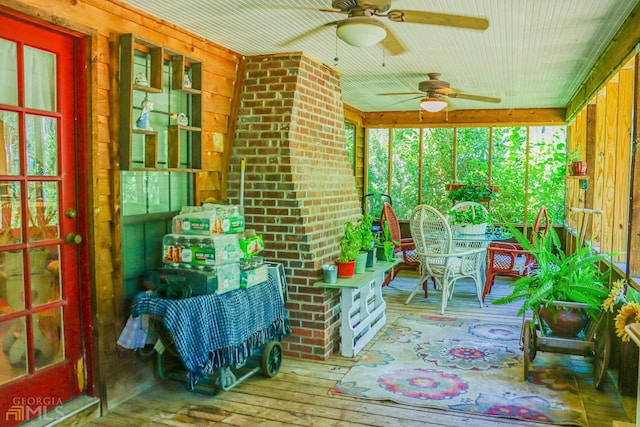 sunroom / solarium featuring ceiling fan