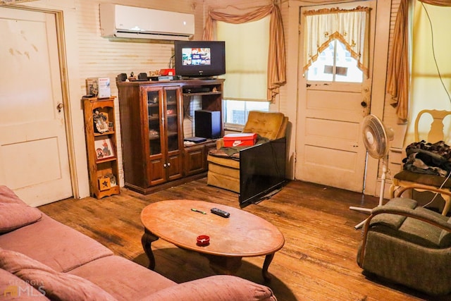 living room featuring dark hardwood / wood-style floors and a wall mounted air conditioner