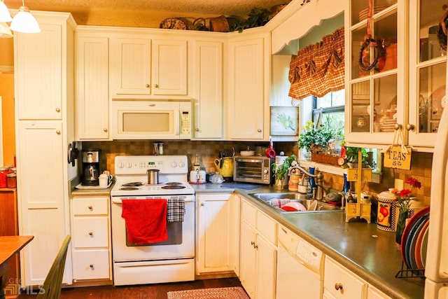 kitchen featuring decorative light fixtures, tasteful backsplash, white cabinets, white appliances, and sink