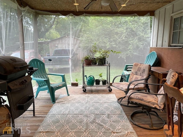 sunroom / solarium featuring ceiling fan and a healthy amount of sunlight