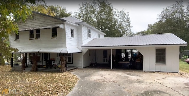 rear view of property featuring a carport