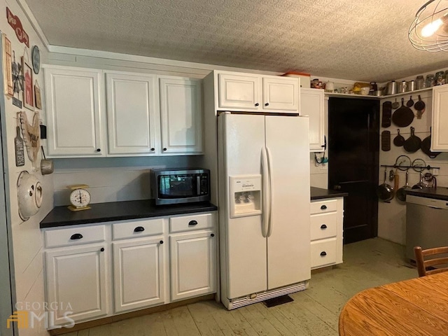 kitchen with white fridge with ice dispenser and white cabinetry