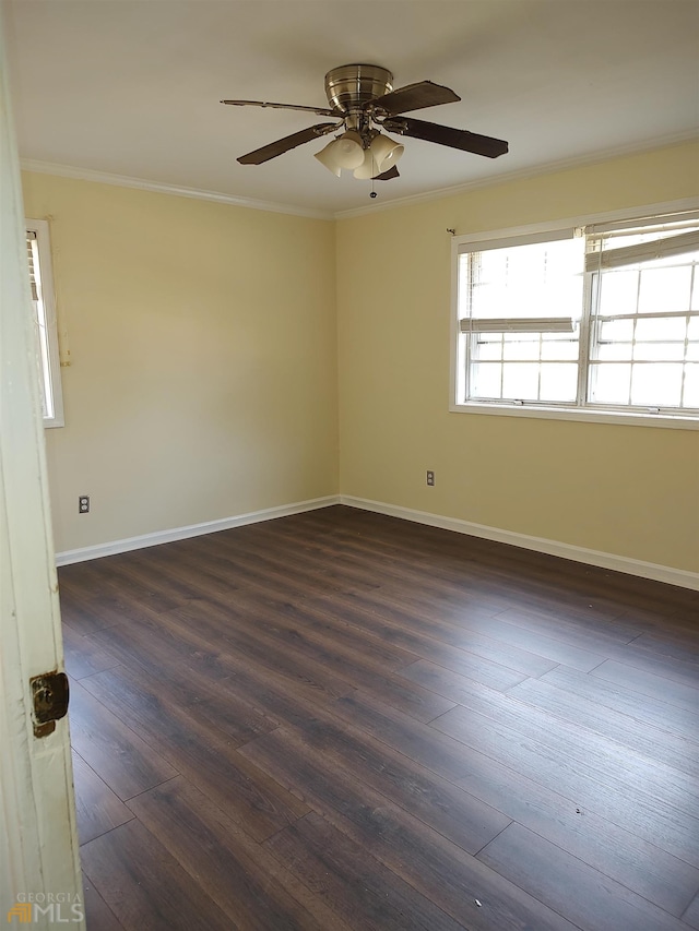 empty room with dark hardwood / wood-style flooring, ceiling fan, and crown molding