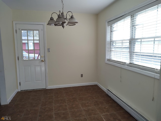 interior space with dark tile floors, an inviting chandelier, and a baseboard heating unit