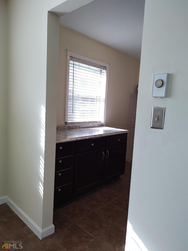 bathroom with tile flooring and vanity