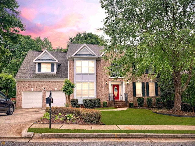 view of front of house featuring a lawn and a garage