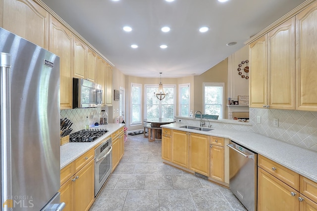 kitchen with sink, light tile floors, hanging light fixtures, backsplash, and stainless steel appliances