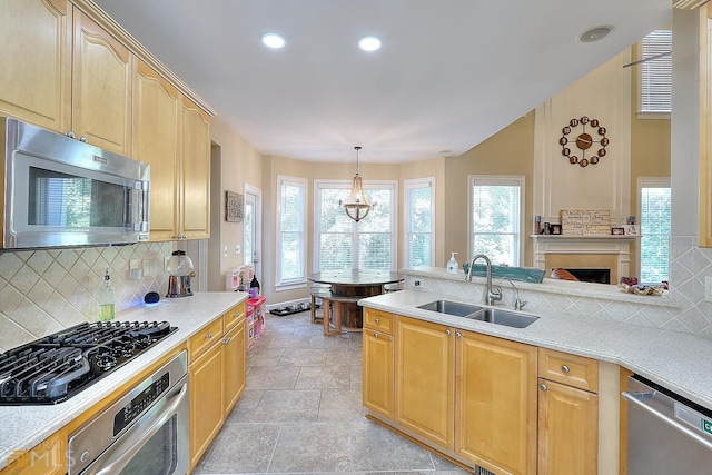 kitchen featuring light tile floors, appliances with stainless steel finishes, a wealth of natural light, and sink