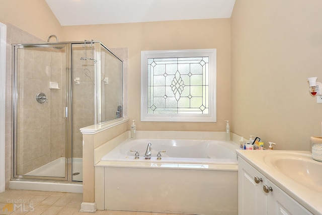 bathroom featuring tile floors, separate shower and tub, and vanity