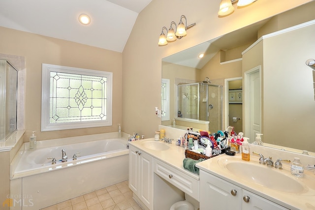 bathroom with tile flooring, lofted ceiling, dual sinks, shower with separate bathtub, and oversized vanity