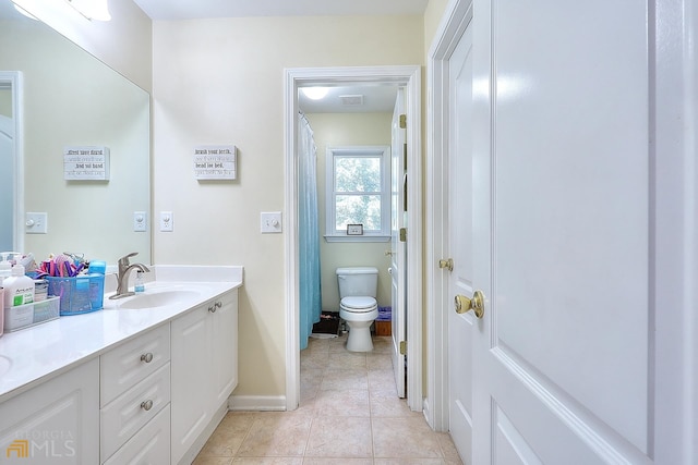 bathroom featuring tile floors, toilet, and oversized vanity