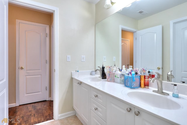 bathroom featuring oversized vanity, hardwood / wood-style floors, and double sink