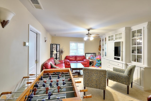 living room featuring carpet floors and ceiling fan