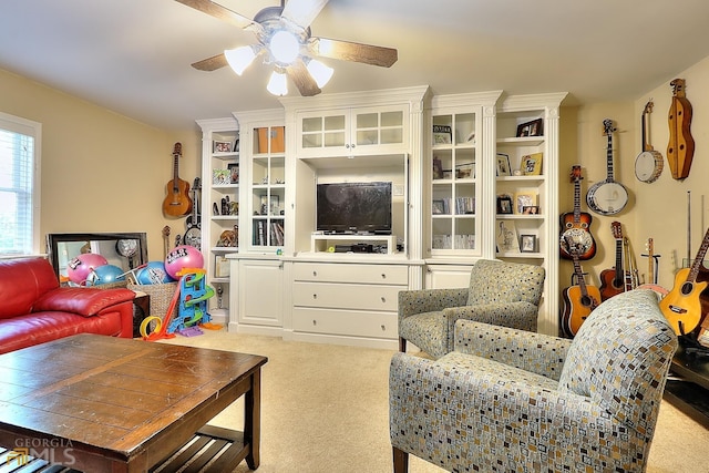 carpeted living room with ceiling fan