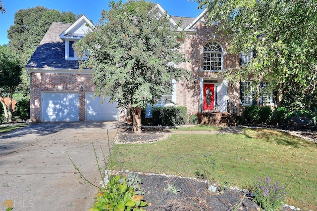 view of front of property featuring a front yard and a garage