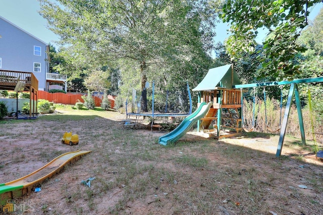 view of play area featuring a trampoline and a deck