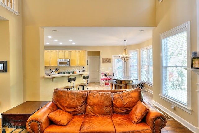 living room with an inviting chandelier and hardwood / wood-style flooring