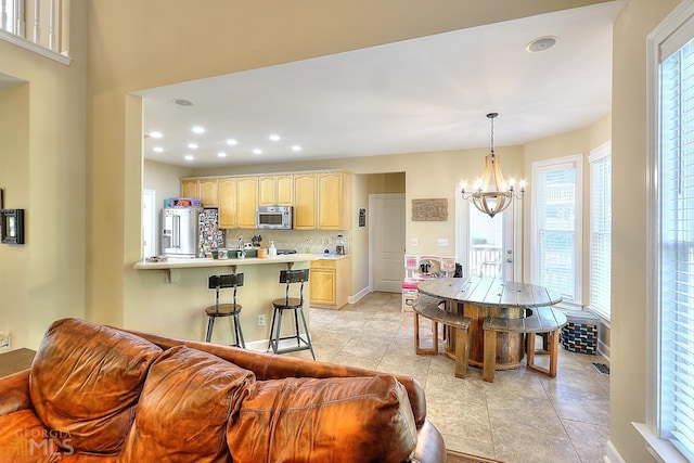 living room featuring a notable chandelier and light tile floors