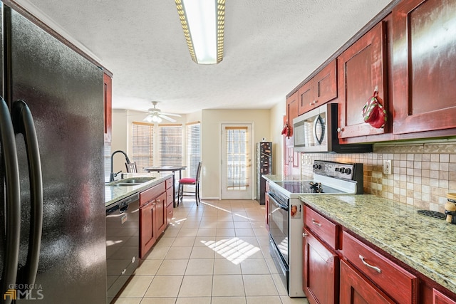 kitchen with black refrigerator, dishwashing machine, backsplash, electric range oven, and sink