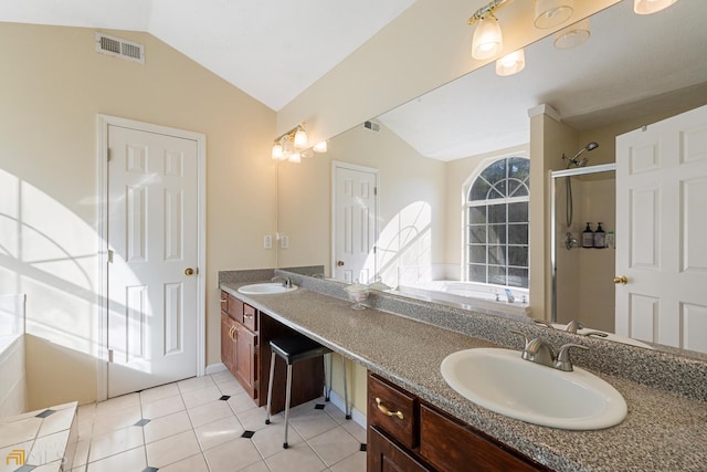 bathroom featuring dual sinks, tile flooring, separate shower and tub, vanity with extensive cabinet space, and vaulted ceiling