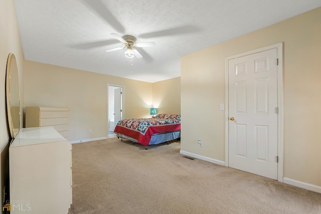 bedroom with light carpet, a textured ceiling, and ceiling fan