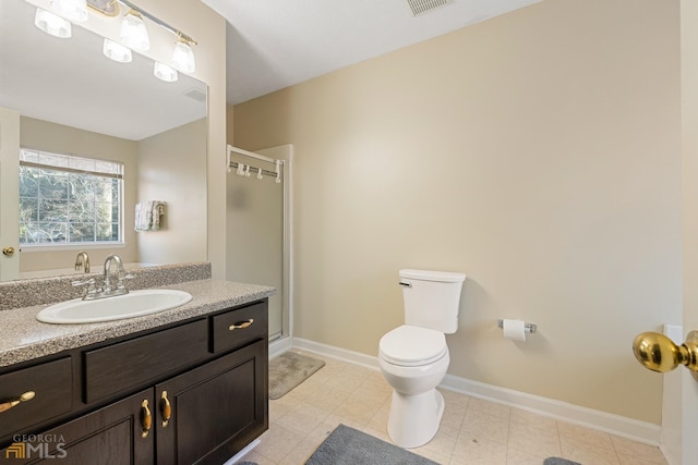 bathroom with toilet, vanity, and tile flooring