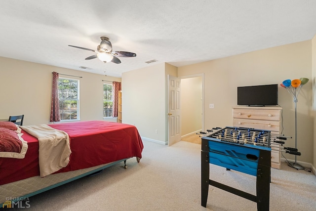 carpeted bedroom with a textured ceiling and ceiling fan