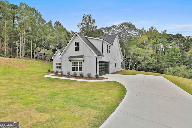 modern inspired farmhouse with a front yard and a garage