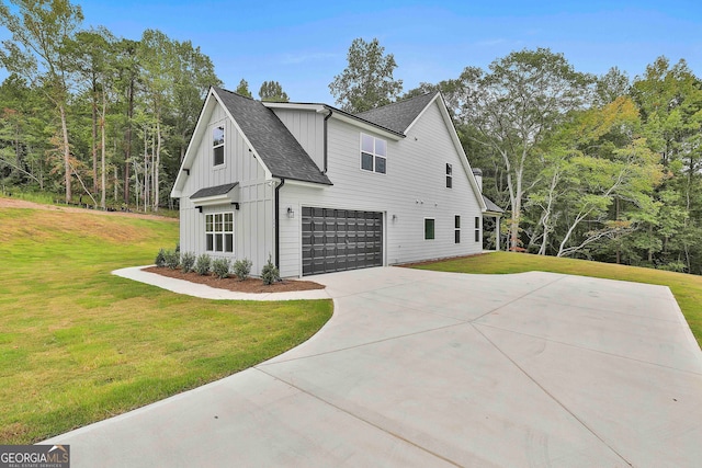 view of side of home with a garage and a lawn