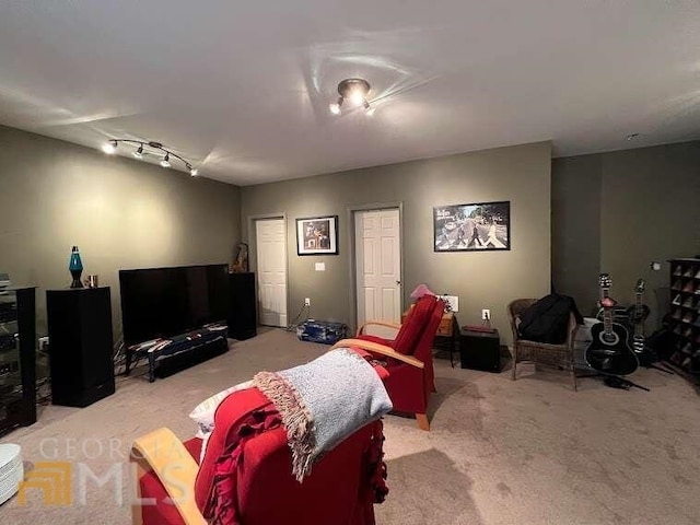 living room featuring light carpet and rail lighting