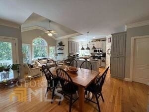 dining area featuring lofted ceiling, ceiling fan, a wealth of natural light, and ornamental molding